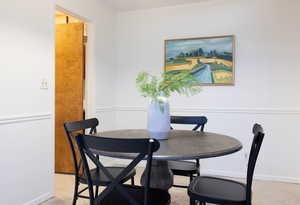 Dining room with light tile patterned floors and ornamental molding