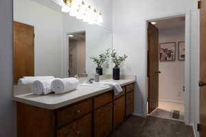 Bathroom with tile patterned floors and vanity