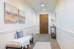 Sitting room featuring light colored carpet