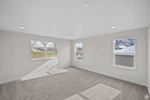 Unfurnished room featuring light carpet