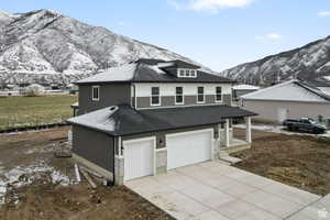 View of front of house featuring a mountain view and a garage