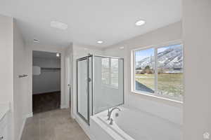 Bathroom with tile patterned floors, vanity, a mountain view, and plus walk in shower