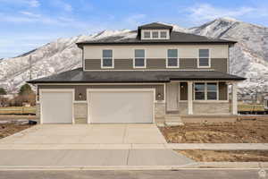 View of front of property featuring a mountain view and a garage