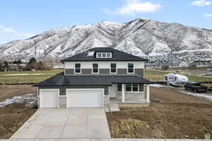 View of front property featuring a mountain view and a garage