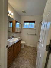 Bathroom featuring vanity and toilet