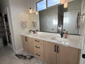 Bathroom featuring vanity and a shower