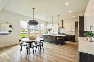 Dining space with light wood-type flooring and sink