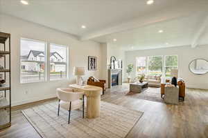 Living room with beamed ceiling and light wood-type flooring