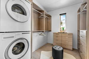 Laundry room featuring stacked washer and clothes dryer