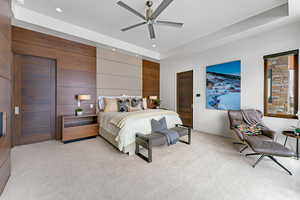 Bedroom with ceiling fan and light carpet