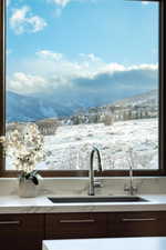 Details with a mountain view, sink, and dark brown cabinets