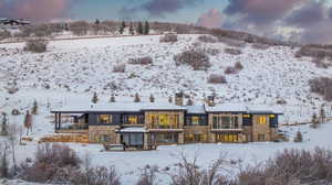 View of snow covered rear of property