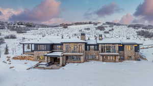 View of snow covered back of property