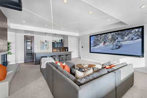 Carpeted living room with a raised ceiling