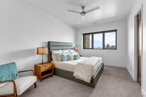 Carpeted bedroom featuring ceiling fan