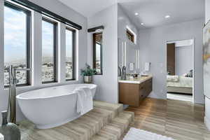 Bathroom featuring vanity, a tub to relax in, and tile patterned floors