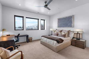 Bedroom with ceiling fan and light colored carpet