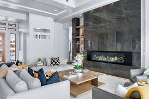 Living room with a fireplace and tile walls