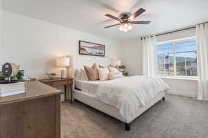 Carpeted bedroom with ceiling fan