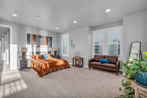 Bedroom featuring light colored carpet