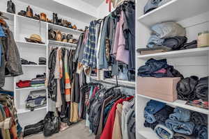 Walk in closet with light carpet