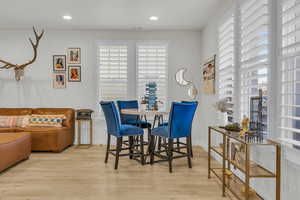 Dining area featuring baseboards, visible vents, wood finished floors, and recessed lighting