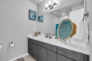 Bathroom featuring tile patterned flooring and vanity