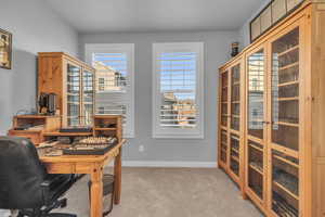 Office with light carpet and french doors