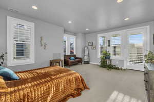 Carpeted bedroom with access to outside