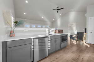 Kitchen featuring a sink, light wood finished floors, and gray cabinets