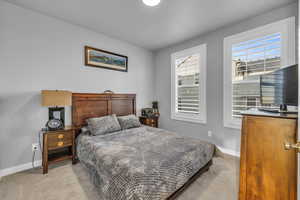 Bedroom featuring light carpet