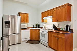 Kitchen with white appliances and sink