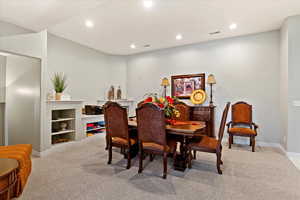 Dining room featuring light colored carpet and built in features