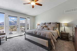 Bedroom featuring a textured ceiling, access to outside, ceiling fan, a mountain view, and carpet floors