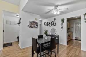 Dining room with ceiling fan and light hardwood / wood-style flooring