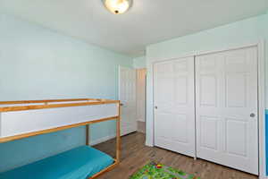 Bedroom featuring hardwood / wood-style floors and a closet