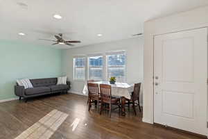 Dining space with ceiling fan and dark hardwood / wood-style floors