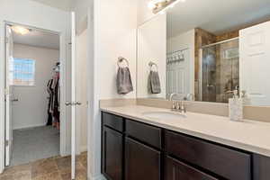 Bathroom with vanity and a shower with shower door