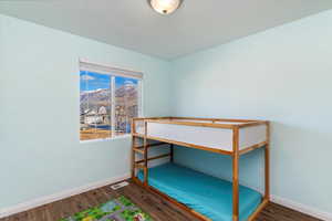 Bedroom featuring a mountain view and dark hardwood / wood-style flooring