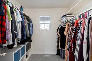 Walk in closet featuring carpet flooring