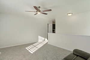 Unfurnished room with ceiling fan and carpet floors