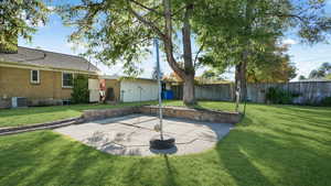 Exterior space with a patio, a lawn, and central air condition unit