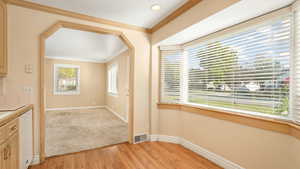 Interior space with ornamental molding and light wood-type flooring