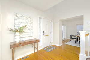 Entrance foyer with wood-type flooring