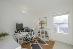 Upstairs office space featuring carpet