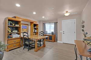 Dining space with light hardwood / wood-style floors