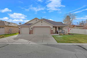 Ranch-style home with a front lawn, a porch, and a garage