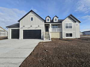 View of front of house featuring covered porch and a garage