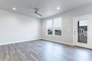 Empty room featuring hardwood / wood-style flooring and ceiling fan