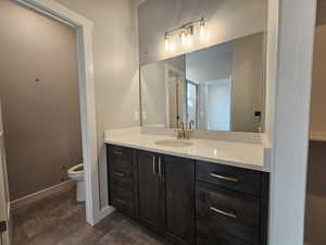 Bathroom featuring vanity and toilet